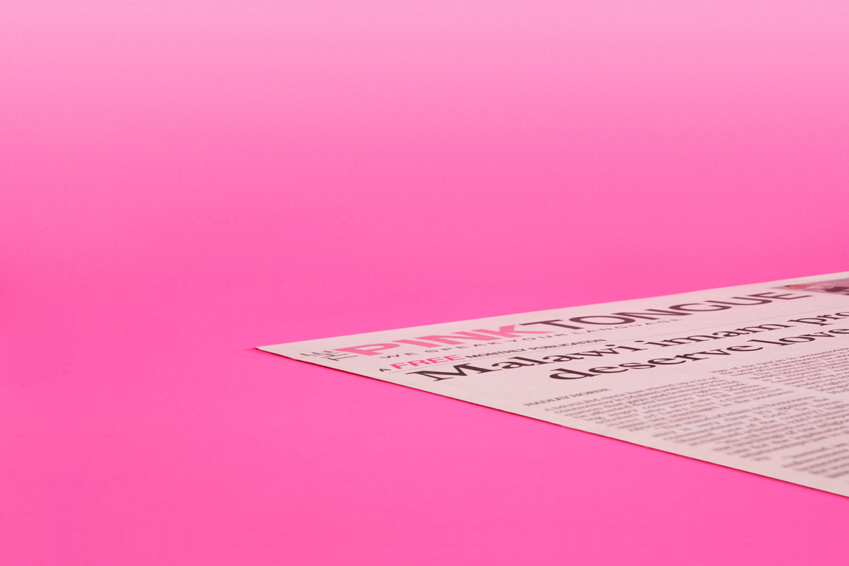 Art directed, cropped photograph of The Pink Tongue LGBTIQ newspaper, publisher of the Squeers comic, on a pink background.