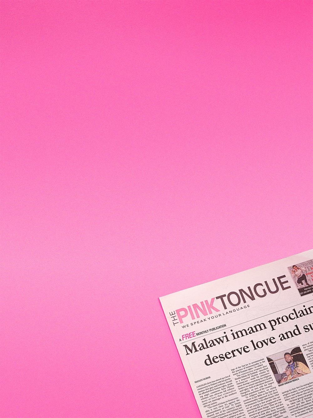 Art directed, cropped, aerial photo of The Pink Tongue LGBTIQ newspaper, publisher of the Squeers comic, on  pink background.